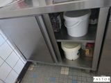 a metal cabinet with buckets on it in a kitchen