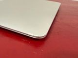 a laptop computer sitting on top of a red table