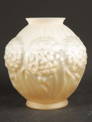 cream colored glass vase with white flowers on a black background