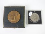 an image of a gold medal in a black box and a silver medal in a black box