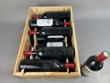 bottles of wine are in a wooden box on a table