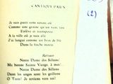 an open book with a piece of paper on top of it