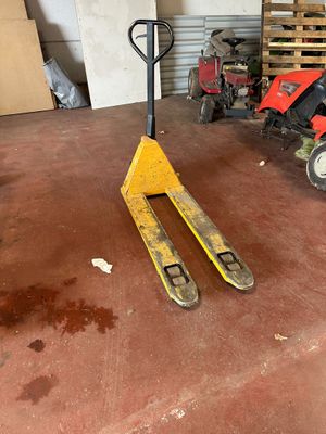 a forklift in a garage with a fork on it