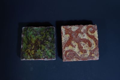 two soap bars sitting on top of a black table