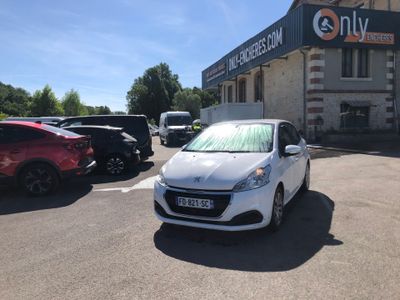 a white car parked in a parking lot in front of a building