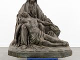 an image of a statue of a woman laying on a man ' s lap