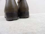 a close up of a pair of shoes on a bed