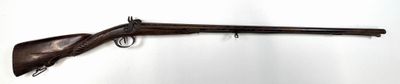 an old gun is hanging on a wall in a room