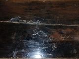 a black piece of wood that has been scratched off