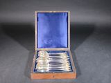 silverware in a wooden case on a black surface
