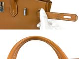 an image of a handbag with a tissue in it
