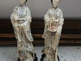 pair of asian figurines of a woman and a man holding a basket