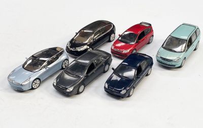 plusieurs petites voitures sont alignées sur une surface blanche
