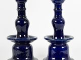 two blue vases that are sitting on a table