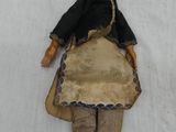 a doll that is laying down on a white sheet