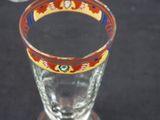 a glass with a design on it sitting on a table