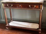 a small table with a marble top on a hard wood floor