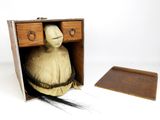 a small wooden box with a doll inside of it
