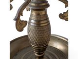 a metal vase that is sitting on a metal tray