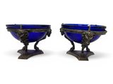 pair of antique blue glass bowls on pedestals on a white background