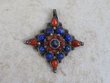 an image of a red, white and blue pendant on a white surface