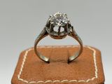 a close up of a diamond ring sitting on top of a wooden box