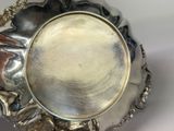 a silver plate that has a picture of a flower on it