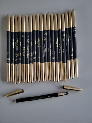 a close up of a group of pencils and a pen on a table