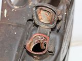 a close up of an old rusted car with a hole in it