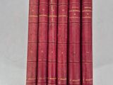 a set of six red books sitting on top of each other