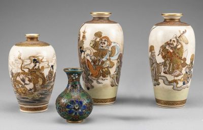 three vases with designs on them sitting next to each other
