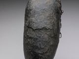 a close up of a sculpture of a rock with a chain on it