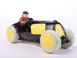 figurine of a black and yellow toy car with a man in a red hat
