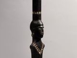 a close up of a wooden pole with a statue on top of it