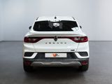 the rear end of a white suv parked in a room