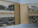 an old photo of a book opened to show pictures of a city
