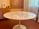 a marble table in the middle of a living room