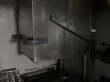 dimly lit kitchen with a stove, oven, and dishwasher