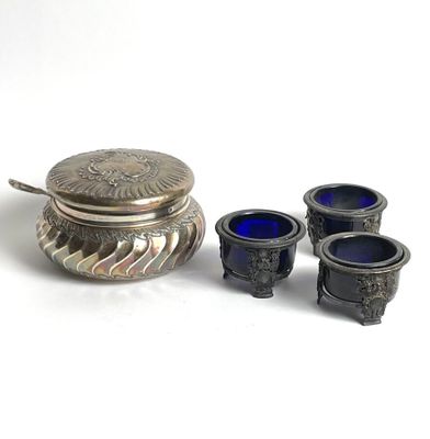 a small silver box with three blue glass cups next to it