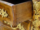 a wooden desk with a marble top and gold decorations
