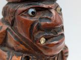 a wooden figurine of a man with a hat on