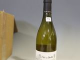 a bottle of wine sitting on a table next to a block of soap