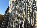 a lot of metal poles leaning against a stone wall