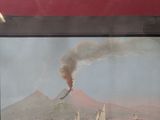 a picture of a picture of a volcano on the water