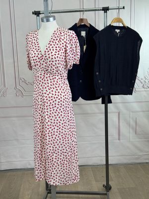 two women ' s dresses on a mannequin stand in front of a white wall