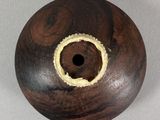 a small wooden object with a hole in it