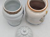 two vases sitting next to each other on a table