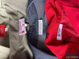 three pairs of pants with labels on them sitting next to each other