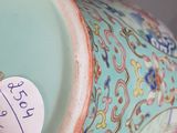 a vase with a tag on it sitting on a table