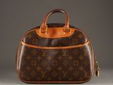 a brown and tan purse with a brown handle